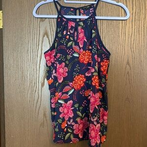 Cute batik-like print tank with front cutouts at neckline. Size large.